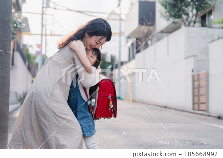 A mother picking up an elementary school girl A mother picking up an elementary school girl 105668992