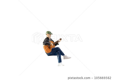 Miniature Musician with guitar isolated on white background with clipping path Miniature Musician with guitar isolated on white background with clipping path 105669382