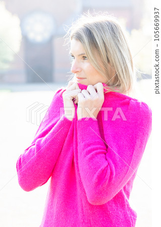 Cozy Millennial Retreat: Young Woman Embracing Comfort in a Fluffy Pink Sweater Cozy Millennial Retreat: Young Woman Embracing Comfort in a Fluffy Pink Sweater 105669937