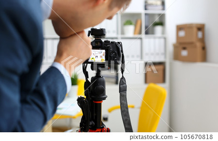 Male arms in suit mount camcorder to tripod Male arms in suit mount camcorder to tripod 105670818