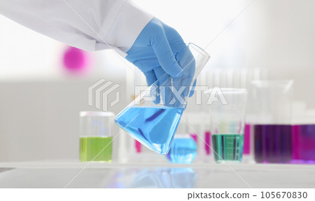 A male chemist holds test tube of glass A male chemist holds test tube of glass 105670830