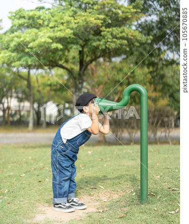 A boy playing in a park A boy playing in a park 105670885