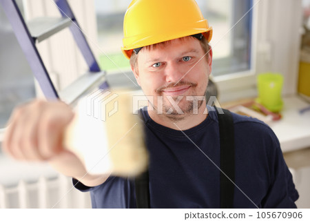 Arm of smiling worker hold brush closeup 105670906