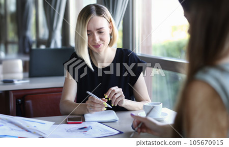 Beautiful smiling cheerful girl at workplace 105670915