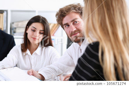 Group of people deliberate on white board 105671274