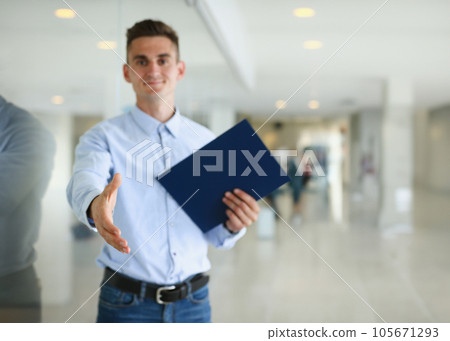 Businessman offer hand to shake as hello in office 105671293
