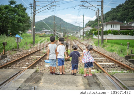 children standing on railroad tracks children standing on railroad tracks 105671482