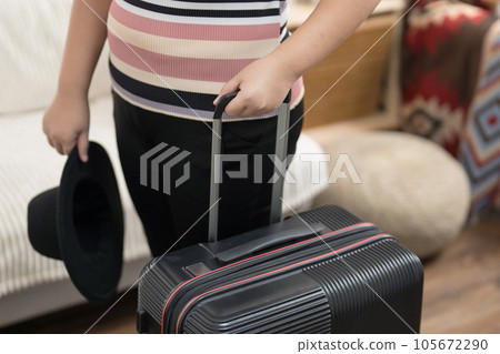 Woman preparing luggage packing in suitcase trolley luggage traveling alone solo girl. Woman preparing luggage packing in suitcase trolley luggage traveling alone solo girl. 105672290