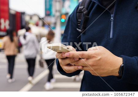 Man in downtown city street ordering taxi using smart phone app Booking taxi using application online on smart phone Man in downtown city street ordering taxi using smart phone app Booking taxi using application online on smart phone 105672347
