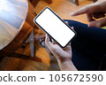 Women's hands holding cell telephone blank copy space screen. smart phone with technology concept. 105672590
