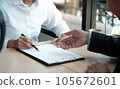 Legal counsel presents to the client a signed contract with gavel and legal law. justice and lawyer concept. 105672601