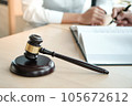 Legal counsel presents to the client a signed contract with gavel and legal law. justice and lawyer concept. 105672612