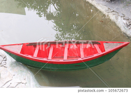 wooden boat on artificial lake in park 105672673
