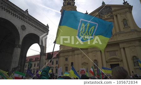 Munich. Germany. Odeonsplatz muenchen. Subject of war between Russia and Ukraine. Protesters holding yellow and blue and European Union flags at demonstration against war in Bayern 105672834
