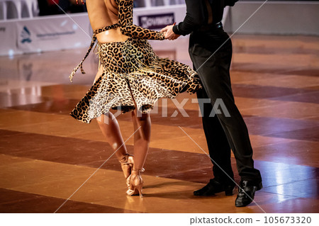 a couple dance a Latin dance. the legs of a dancing couple 105673320