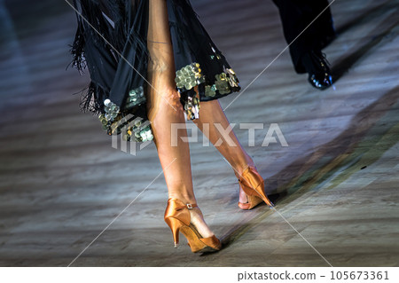 Legs of young dancers on the dance floor Legs of young dancers on the dance floor 105673361