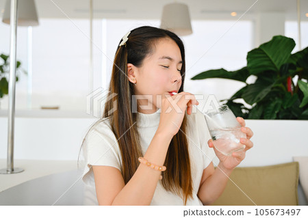 A woman is relaxing in a cafe after work on the weekend. The photo is of high quality. A woman is relaxing in a cafe after work on the weekend. The photo is of high quality. 105673497