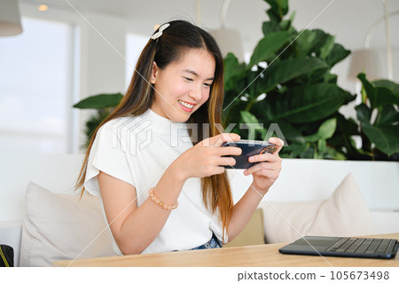 A woman is using a smart phone for various daily activities. The photo is of high quality. A woman is using a smart phone for various daily activities. The photo is of high quality. 105673498