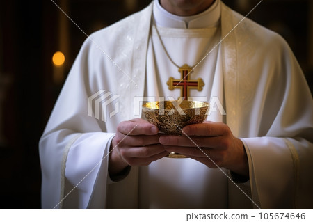 Catholic priest administers Holy Communion 105674646