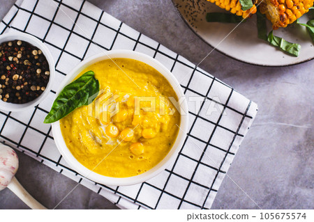 Delicious corn cream soup in a bowl on the table top view Delicious corn cream soup in a bowl on the table top view 105675574
