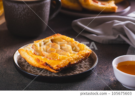 Upside down puff pastry apple tart on a breakfast plate Upside down puff pastry apple tart on a breakfast plate 105675603