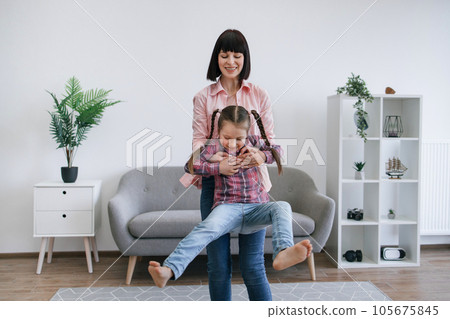 Mom twirling daughter around while staying indoors on day Mom twirling daughter around while staying indoors on day 105675845
