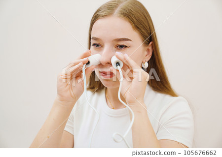 A patient on a magnetotherapy procedure on the nose A patient on a magnetotherapy procedure on the nose 105676662