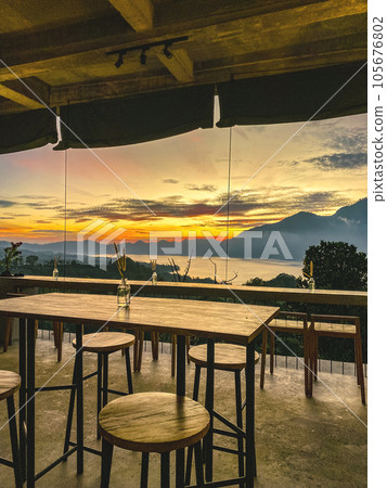 Empty cafe on sunrise with view on Batur volcano Empty cafe on sunrise with view on Batur volcano 105676802