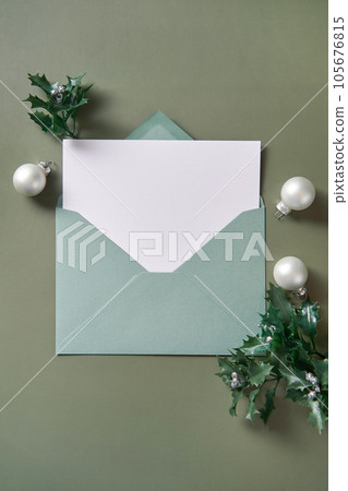 Christmas card flat lay. Empty card in green envelope. Mockup. Christmas card flat lay. Empty card in green envelope. Mockup. 105676815