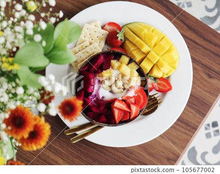 Smoothie bowl with mango, strawberry, dragon fruit 105677002