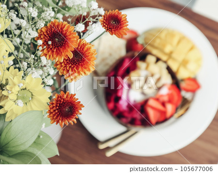 Flowers  bouquet with smoothie bowl on background closeup 105677006