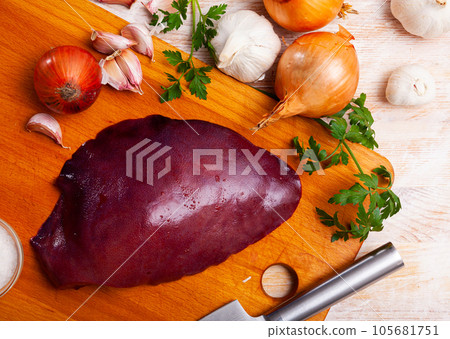 Raw pork liver on wooden table 105681751