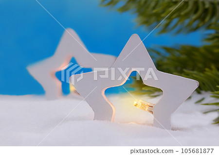 Two stars with lights in snow. Branches of Christmas tree. New Year. Copy space 105681877