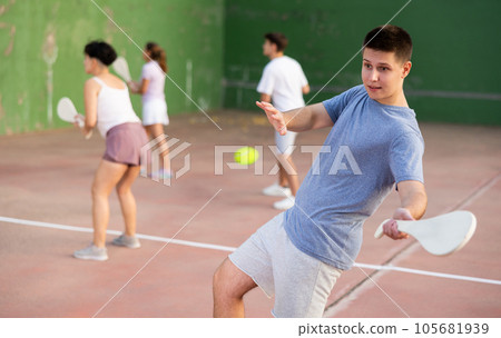 Young man playing Basque pelota on outdoor pelota court Young man playing Basque pelota on outdoor pelota court 105681939