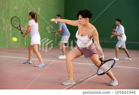 Woman serving ball during frontenis game outdoors 105681948