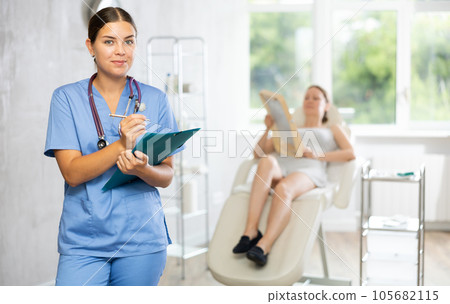 Young female doctor making notes in medical room 105682115