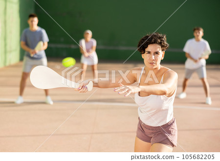 Woman playing Basque pelota on outdoor pelota court Woman playing Basque pelota on outdoor pelota court 105682205