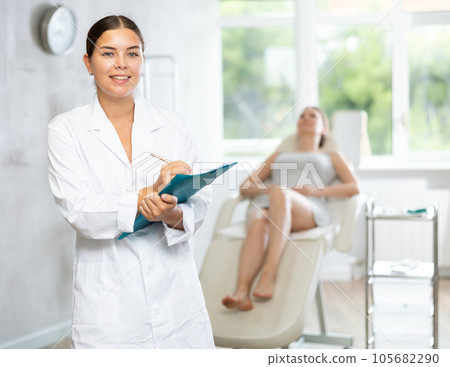Young female doctor making notes in medical room Young female doctor making notes in medical room 105682290