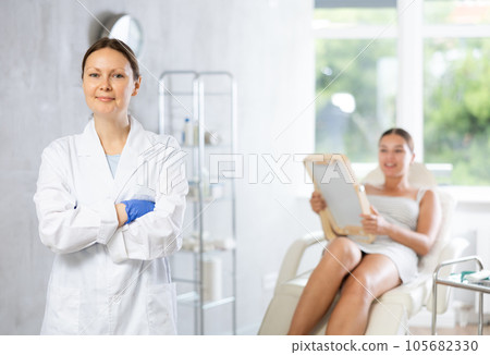 Adult female doctor posing in medical room Adult female doctor posing in medical room 105682330