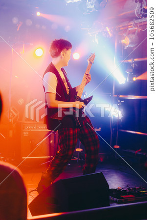 A young man playing the guitar A young man playing the guitar 105682509