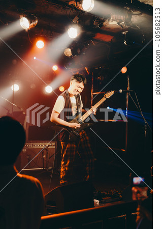 A young man playing the guitar 105682513