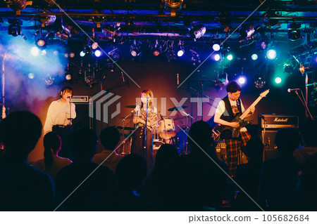 A young band man performing live at a live house 105682684