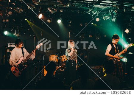 A young band man performing live at a live house 105682698