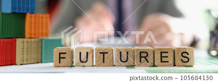 Word futures collected from cubes with cargo containers on office desk and business man in background. 105684130