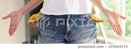 Woman with empty pockets gesticulates that she has no money close-up. 105684155
