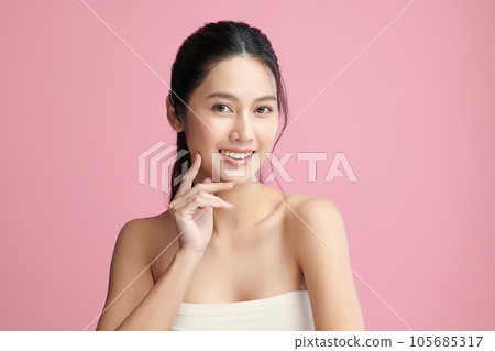Beautiful young asian woman with clean fresh skin on pink background, Face care, Facial treatment, Cosmetology, beauty and spa, Asian women portrait. 105685317