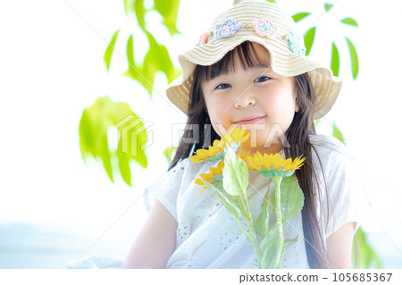 Girl's portrait A girl holding a sunflower Girl's portrait A girl holding a sunflower 105685367