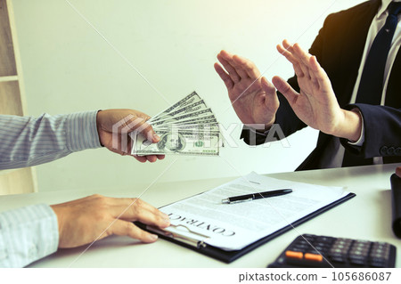 Businessperson refusing bribe given money by partner with anti bribery corruption concept. Businessperson refusing bribe given money by partner with anti bribery corruption concept. 105686087