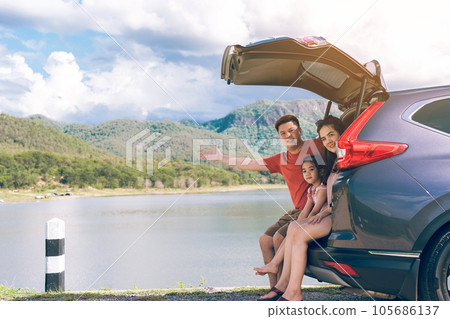 Summer vacations.Happy family enjoying trip with their favorite car. Holiday and travel family concept. Summer vacations.Happy family enjoying trip with their favorite car. Holiday and travel family concept. 105686137