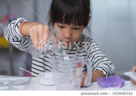 Cute little girl making DIY plaster and painting at home. Children paint on plaster sculptures with family on holiday. Imagination and creativity activities. Cute little girl making DIY plaster and painting at home. Children paint on plaster sculptures with family on holiday. Imagination and creativity activities. 105686582